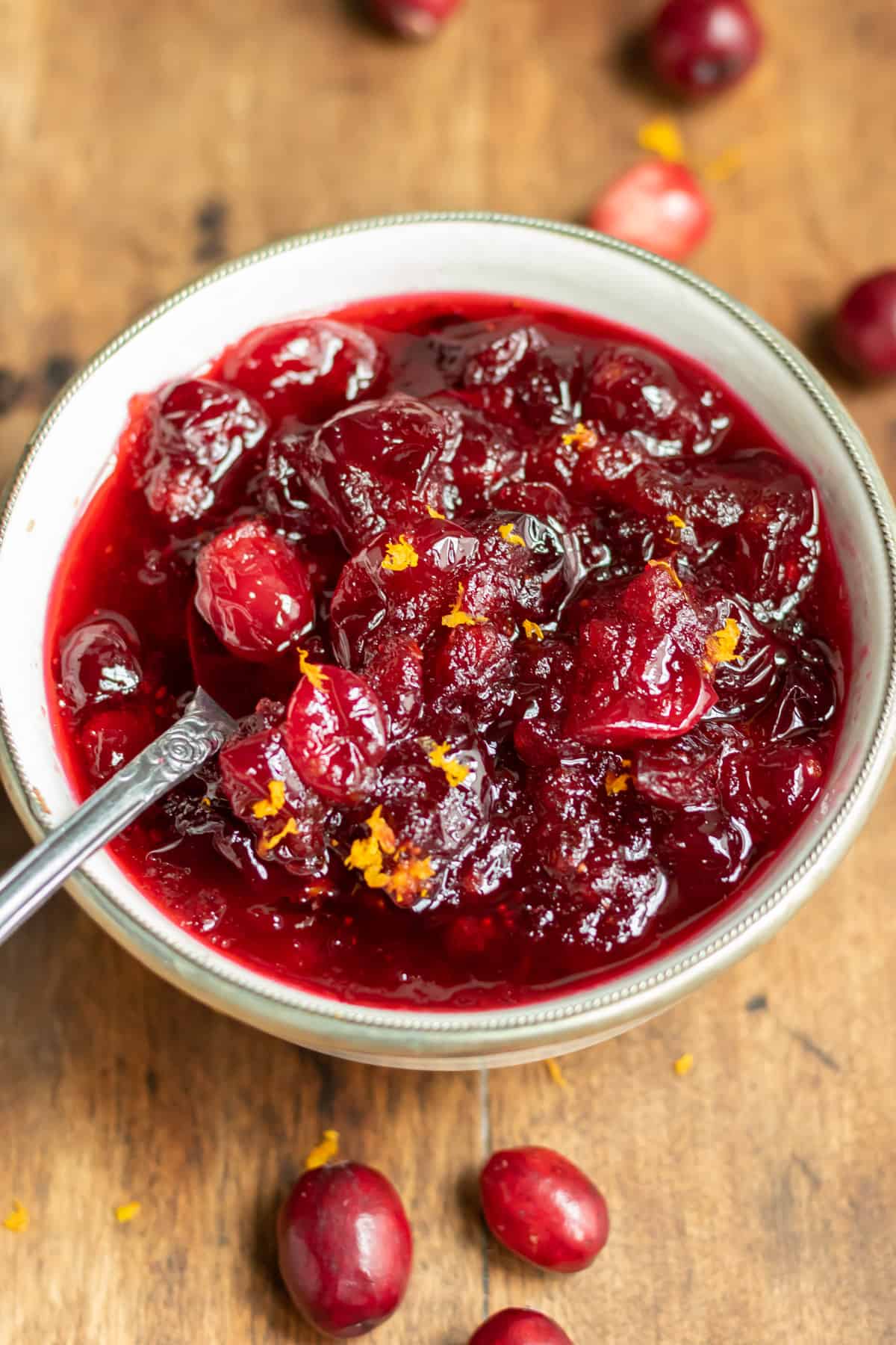 A dish of cranberry sauce with a spoon in it.