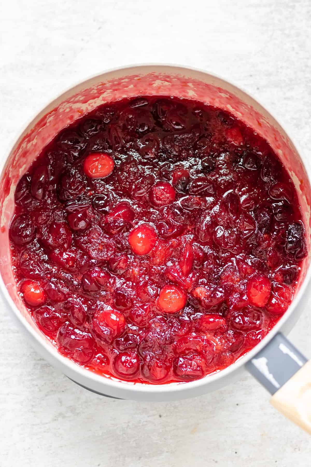 Cooked cranberry compote in a pot.