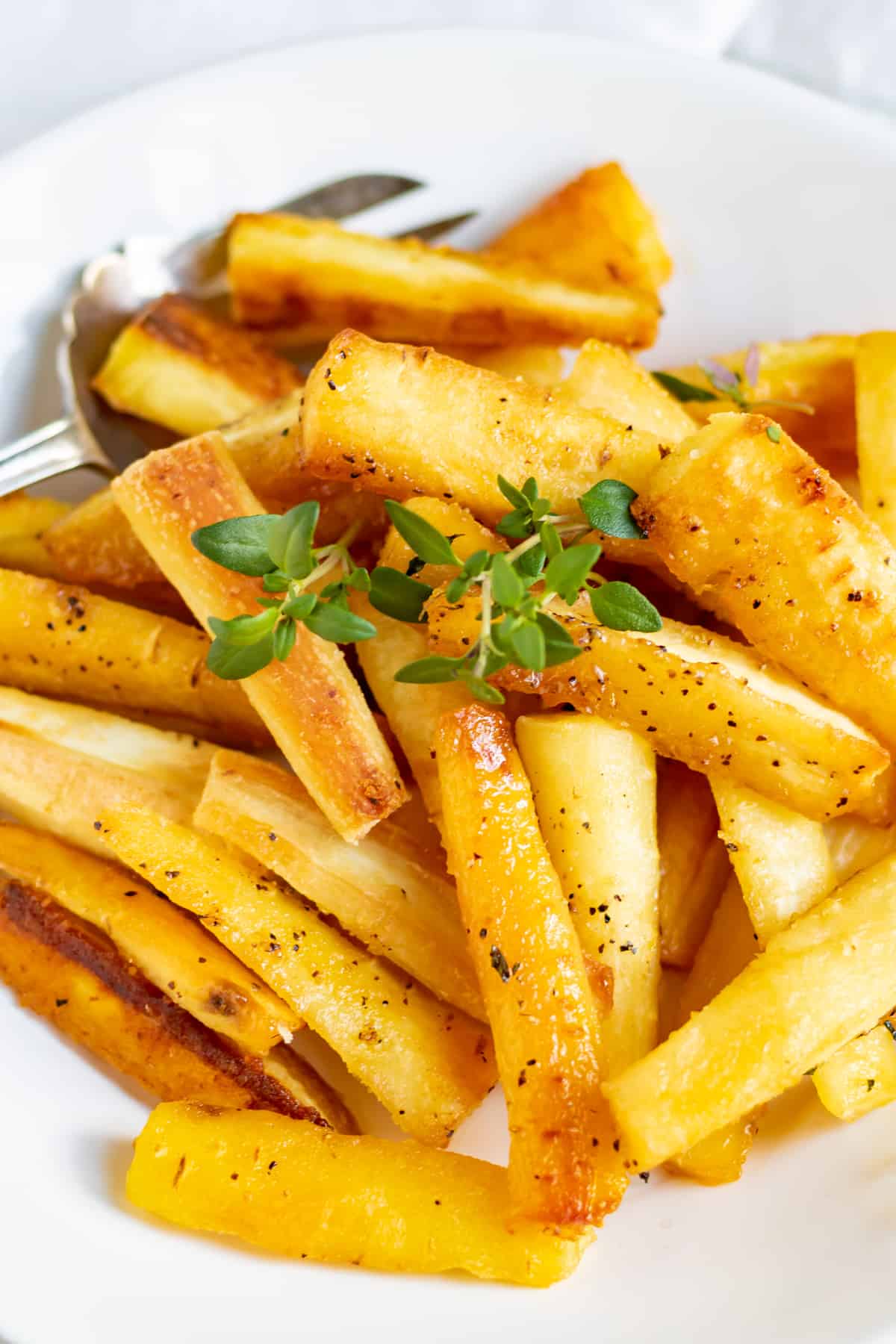 Close up of a pile of roasted parsnips.