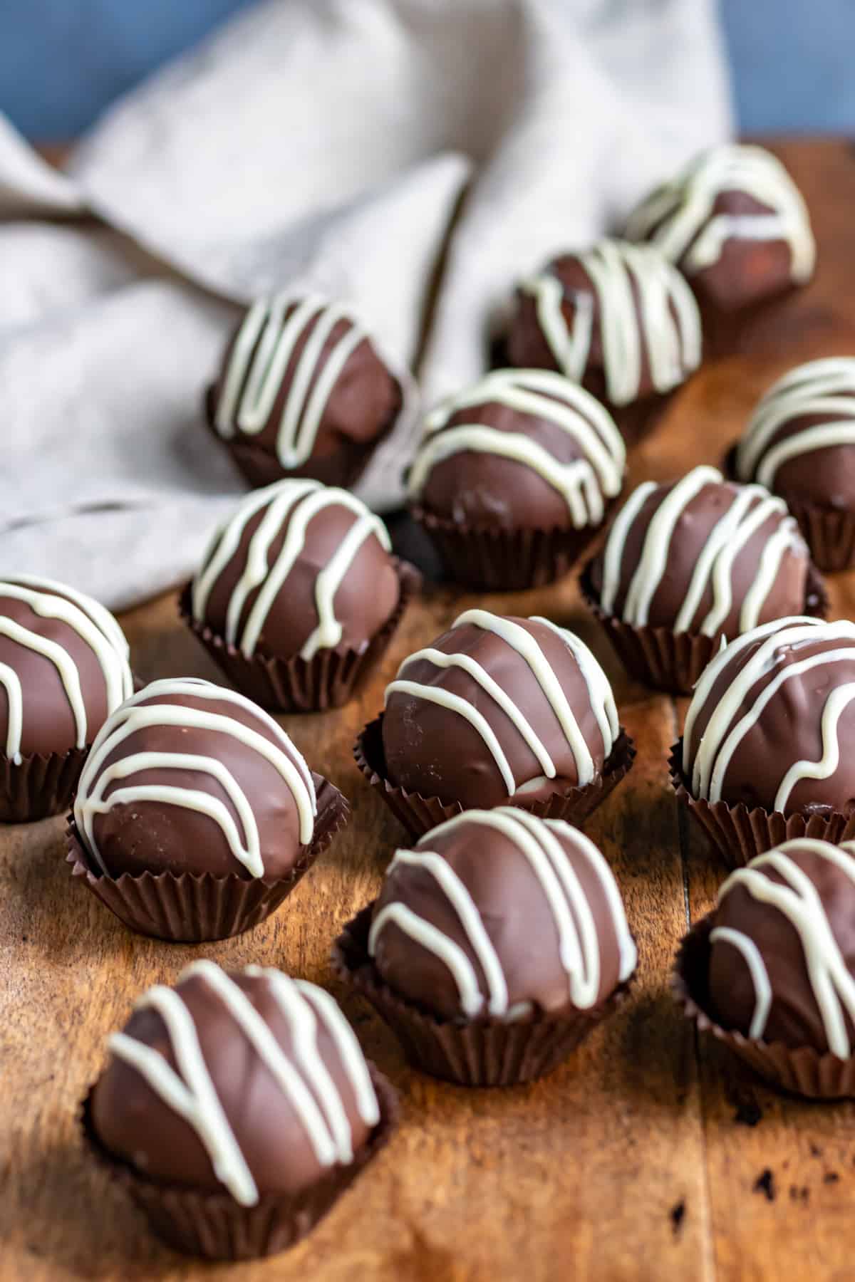 A table of chocolate covered marzipan balls.