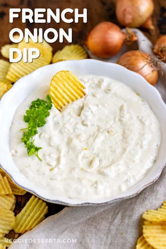 A chip in a bowl of dip, with text: French Onion Dip.