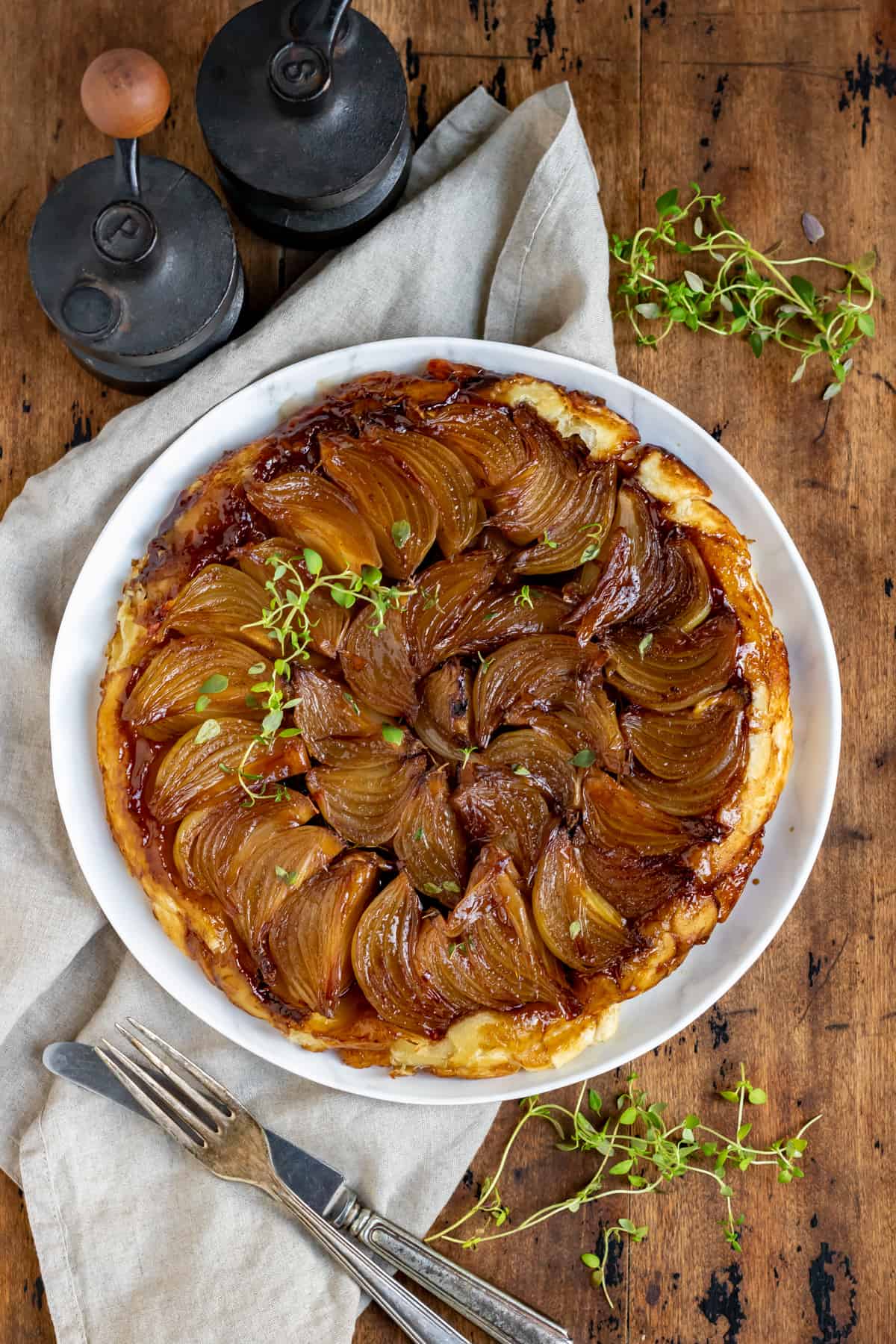 Wooden table with an onion tart.
