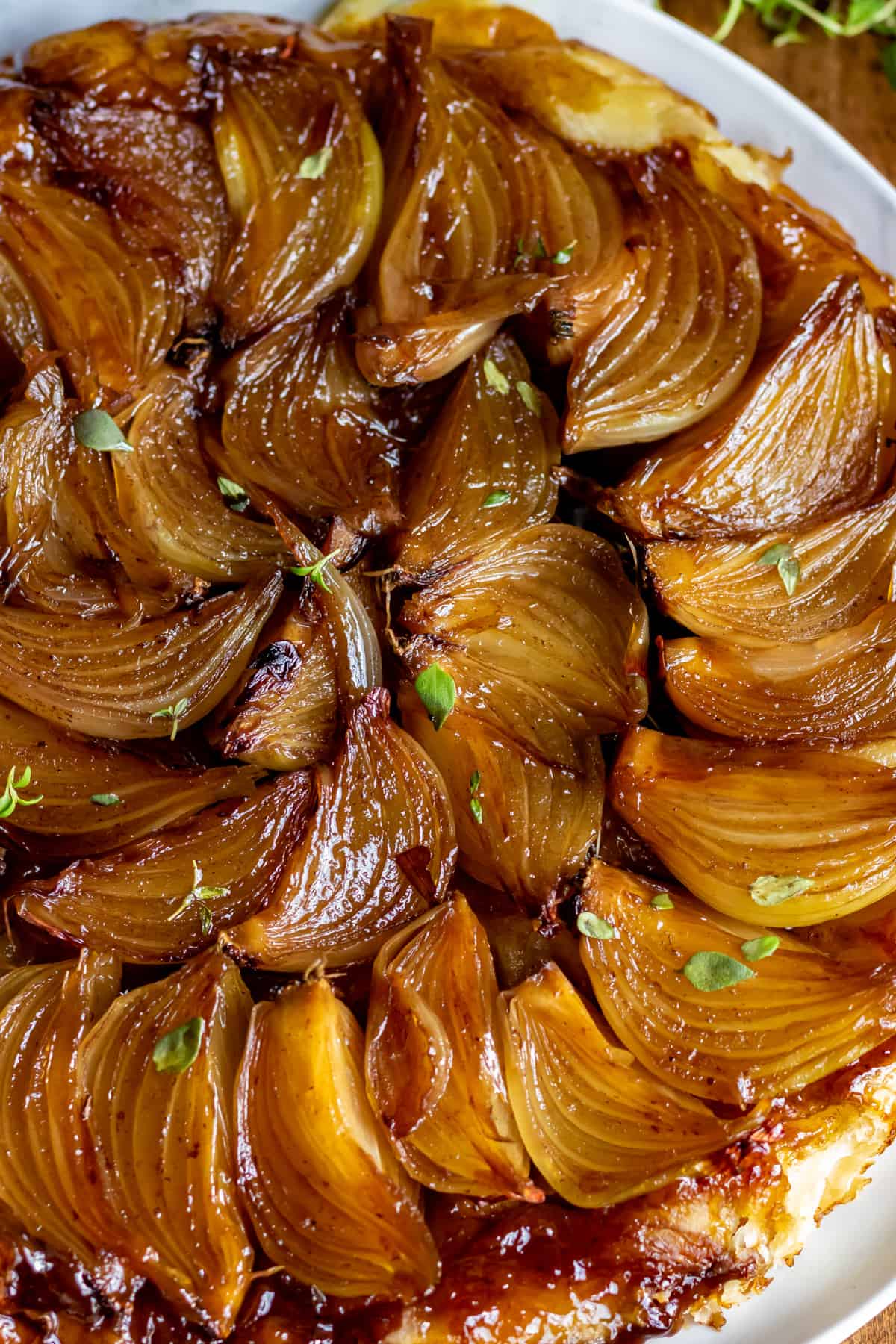 Close up of rows of onions on a tart.