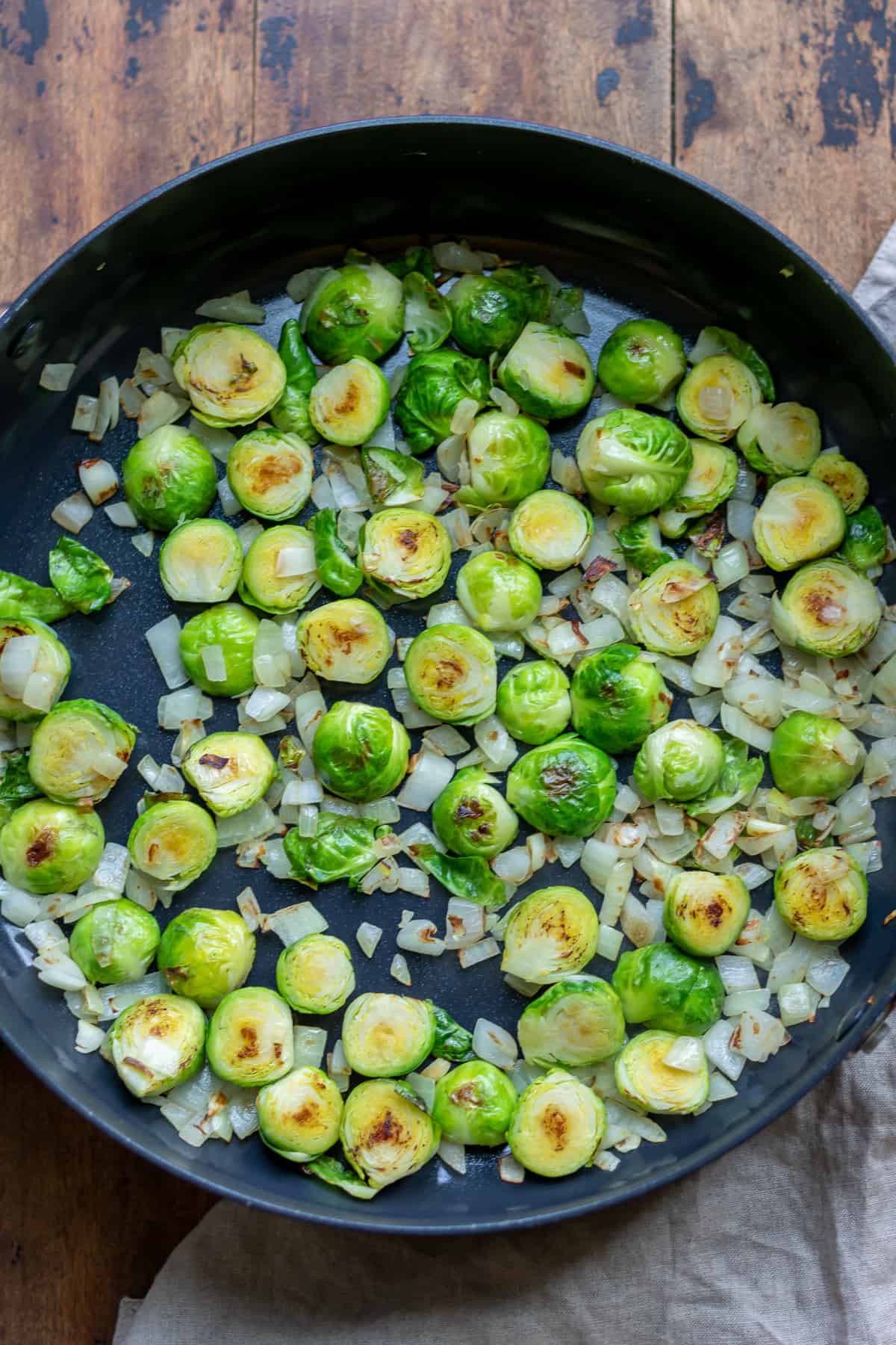 Frying the Brussels sprouts in a pan.