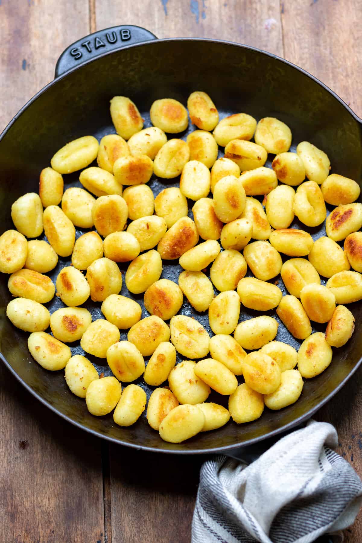 A skillet of pan fried gnocchi.
