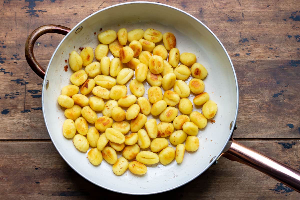 Cooked gnocchi in a pan.