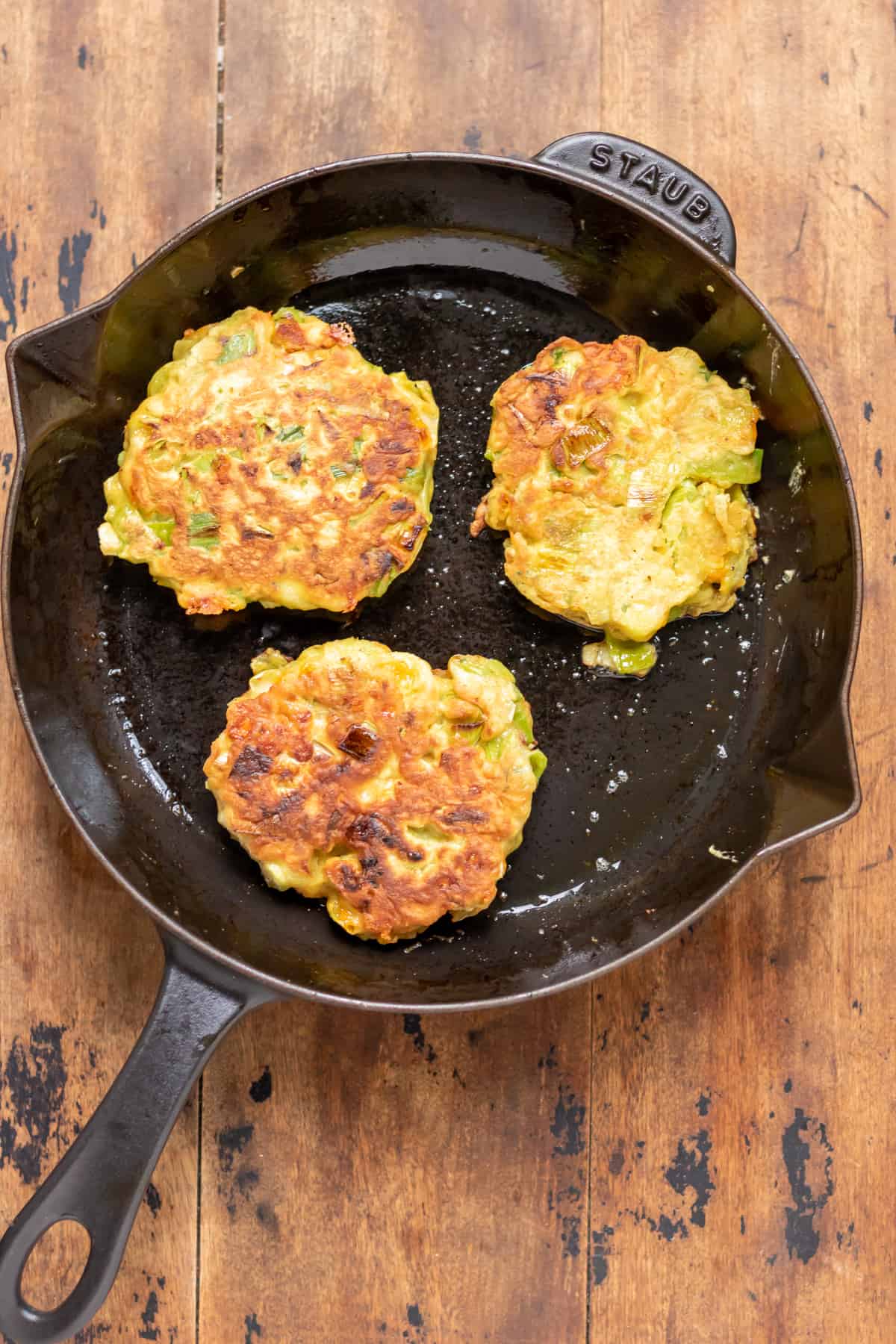 Fritters cooked in a pan.