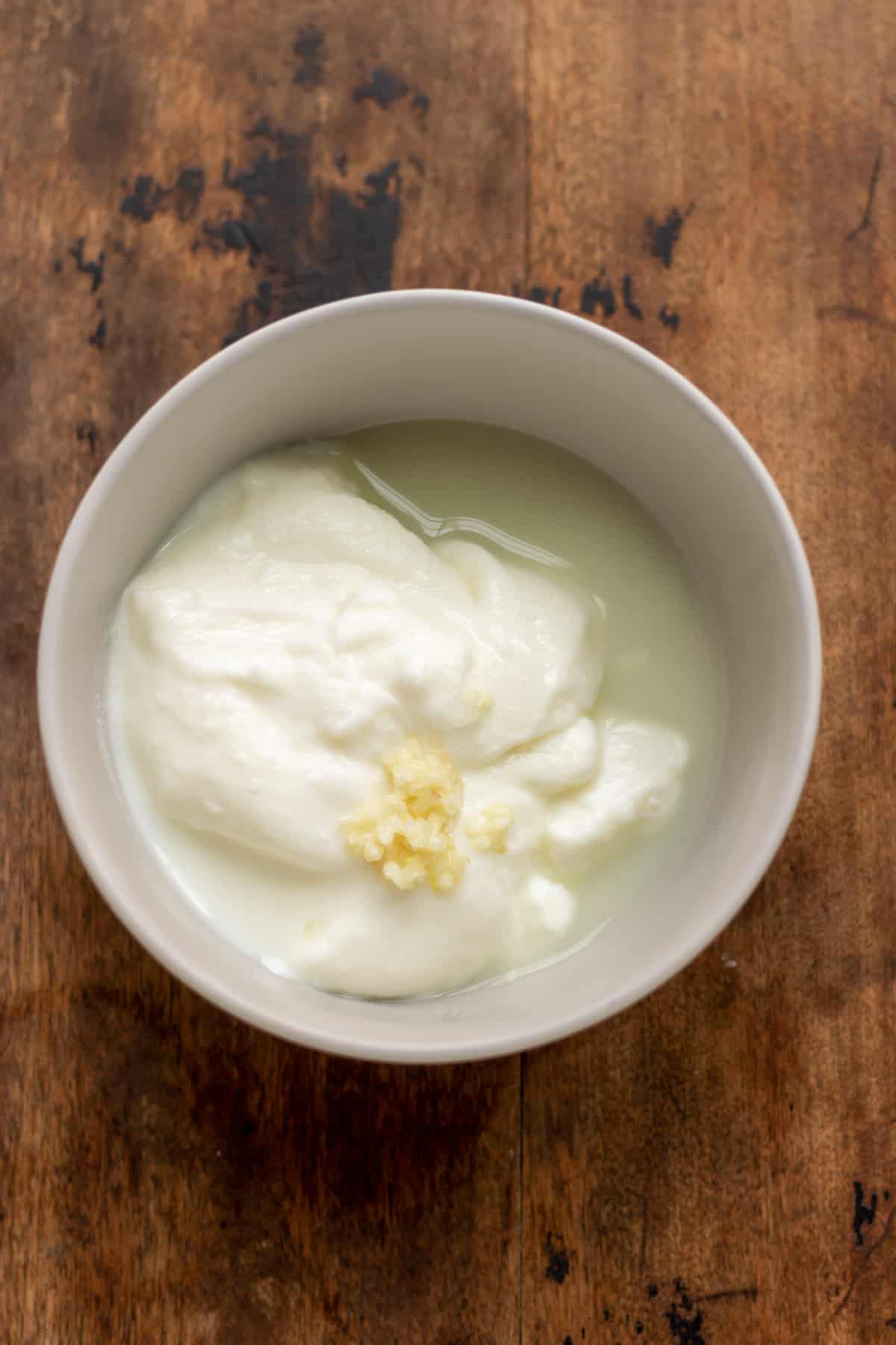 Garlic yogurt sauce ingredients in a bowl.