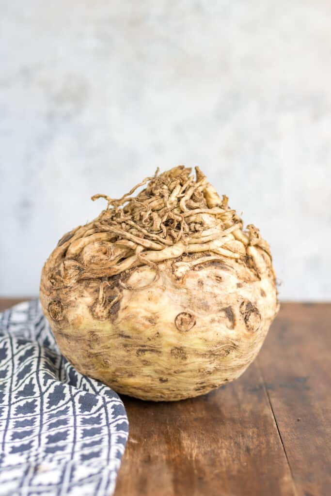 A celeriac (celery root) on a table.