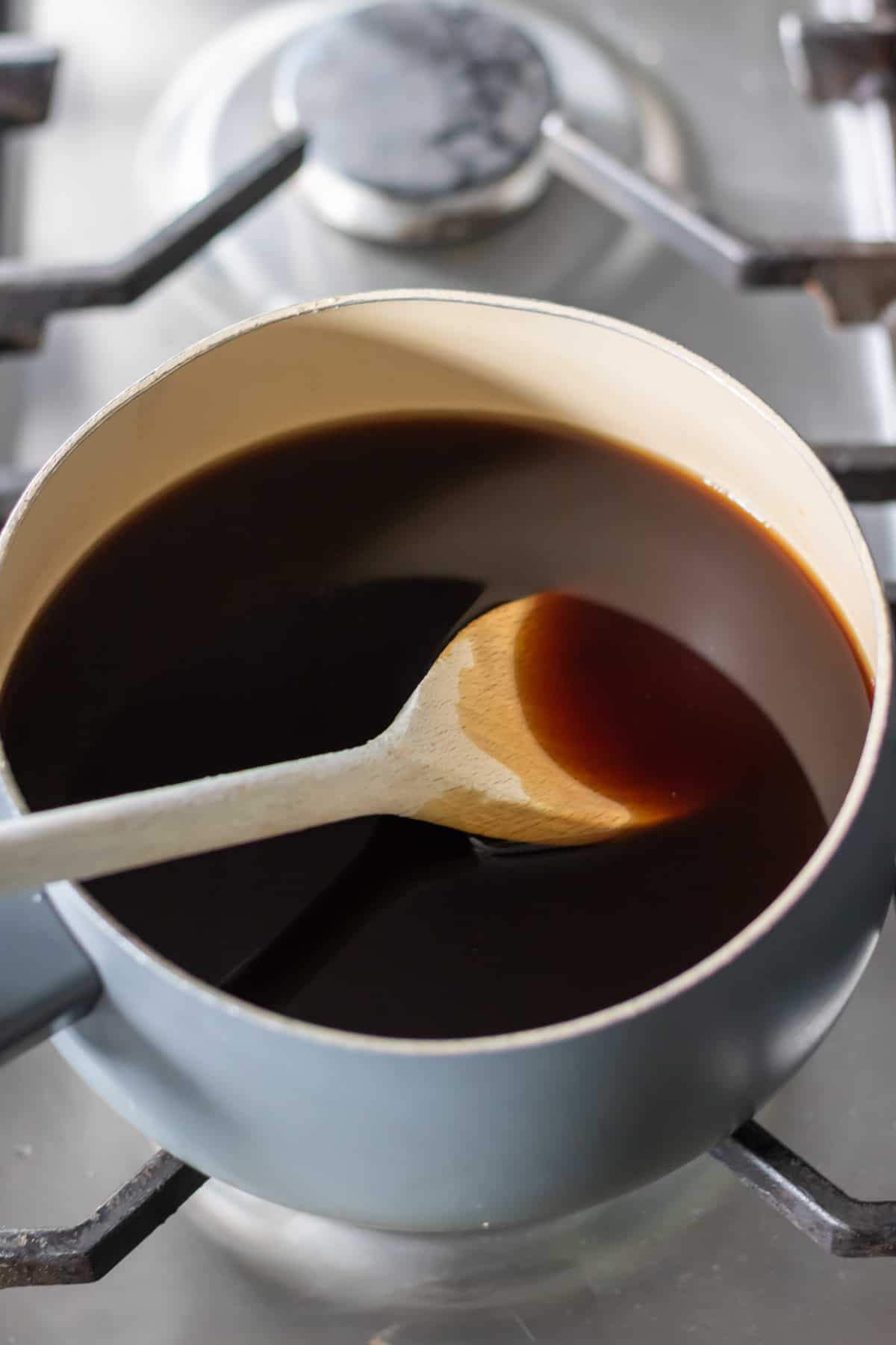 A pot with coffee and sugar being simmered.