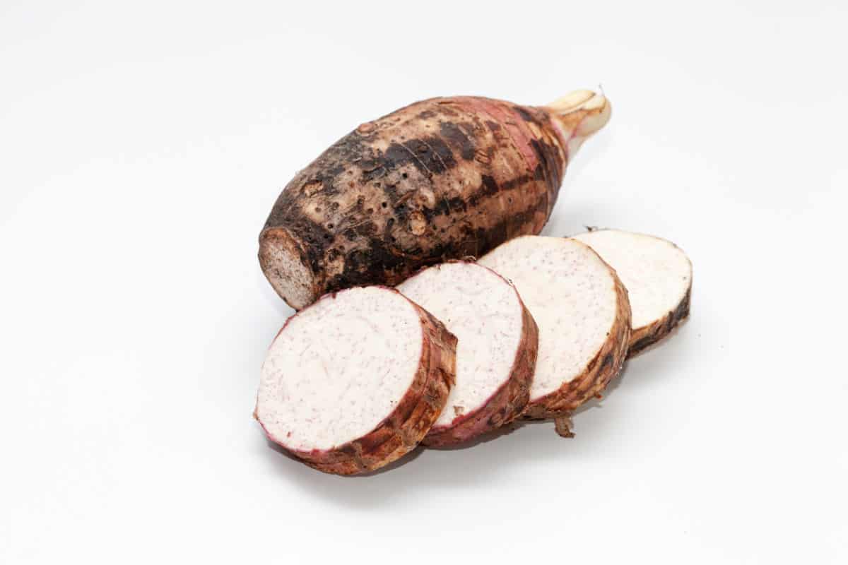 A dasheen (taro) with slices in front.