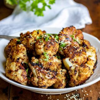 Close up of a dish of roasted miso cauliflower.