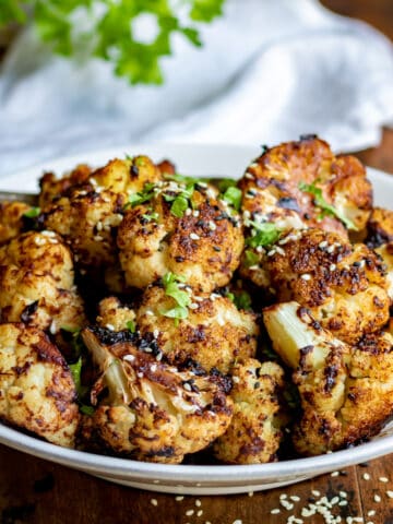 Close up of a dish of roasted miso cauliflower.