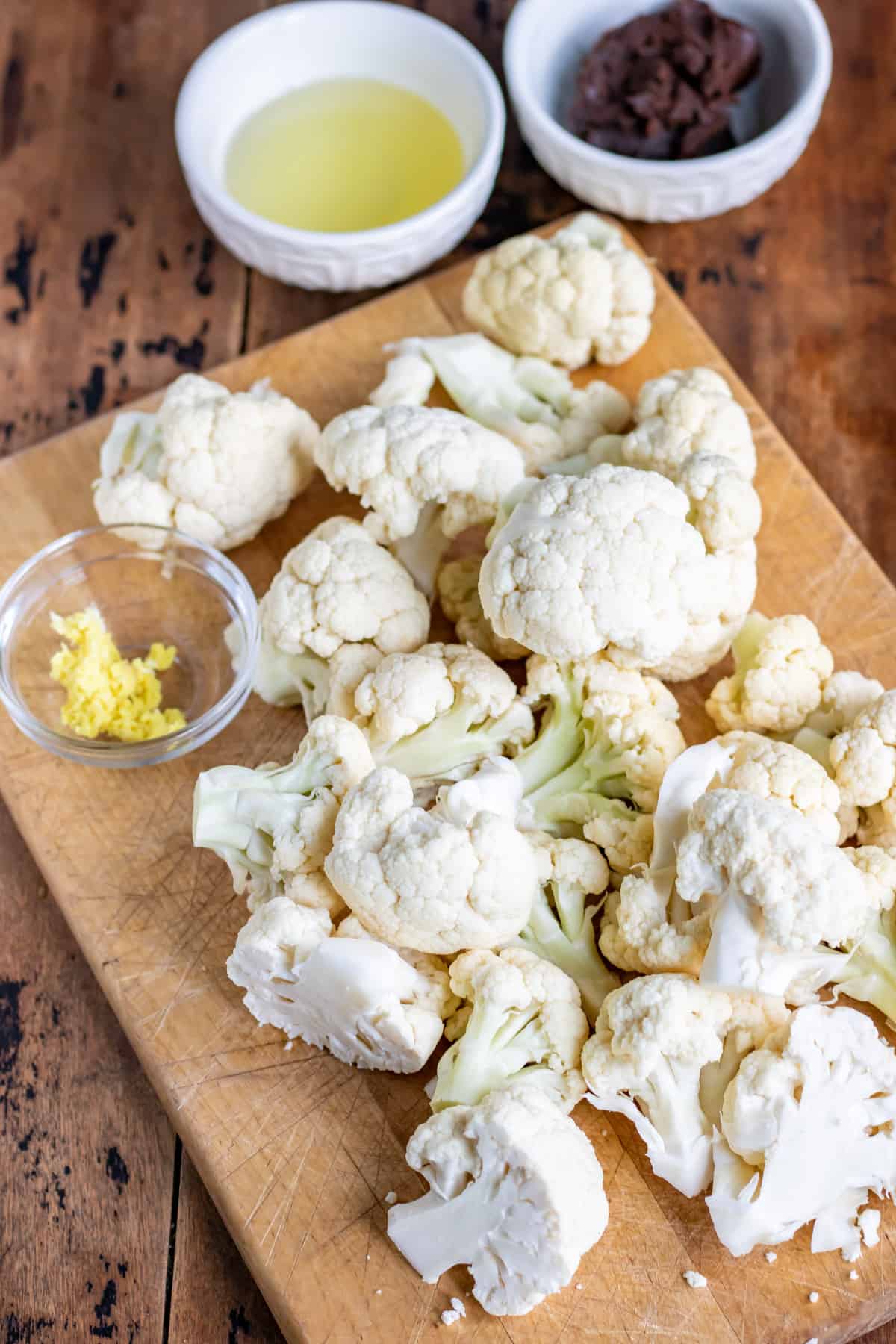 Chopped cauliflower next to ginger and miso.