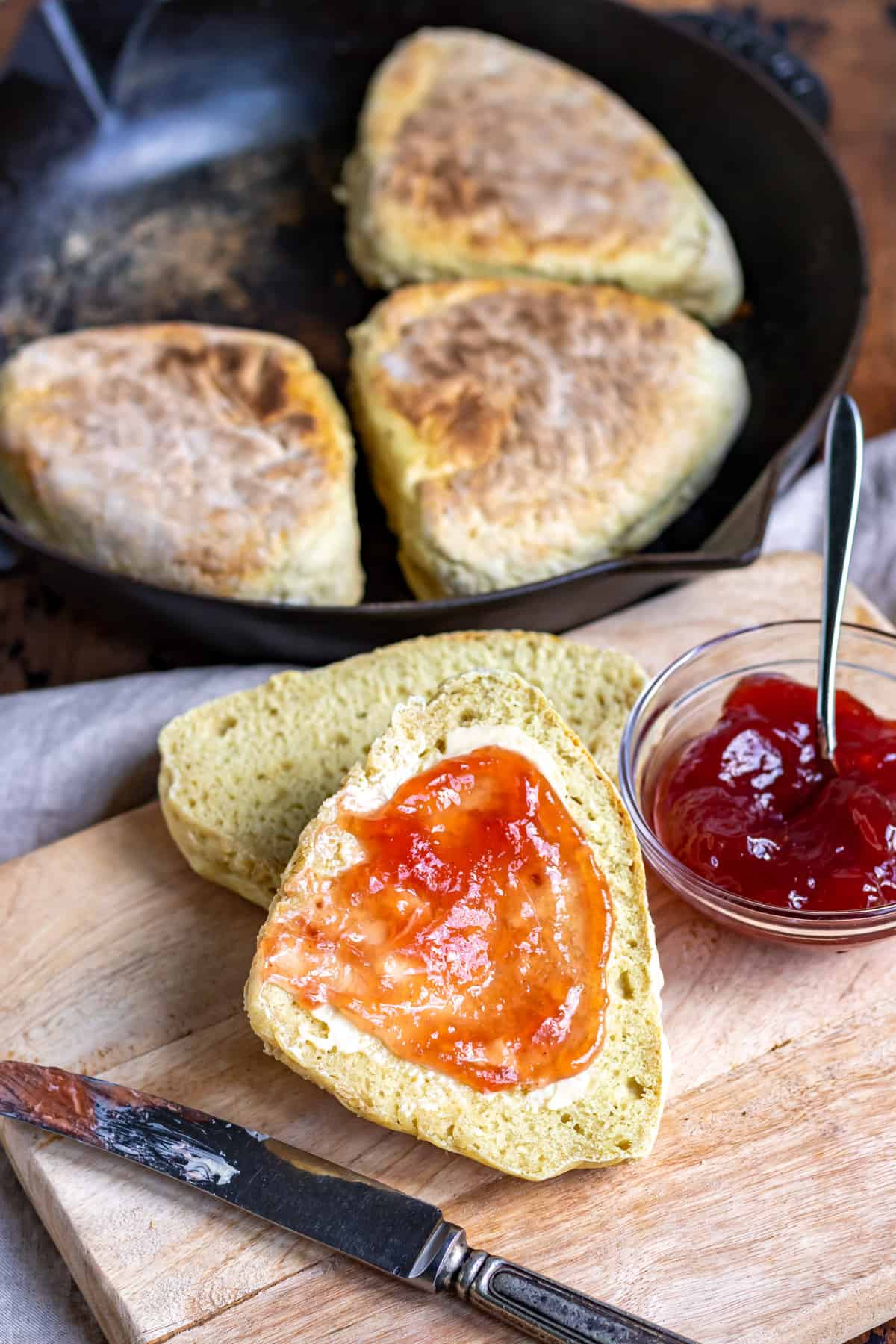 A table with soda farls spread with butter and jam.