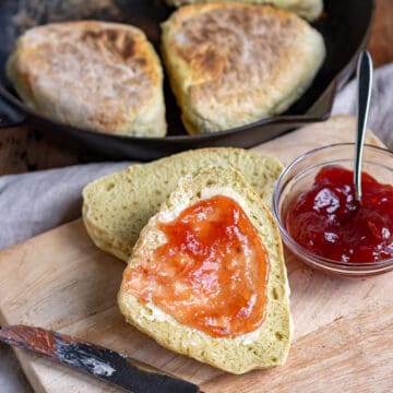 A table with soda farls spread with butter and jam.