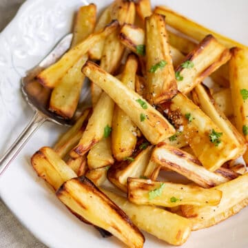 A serving dish of air fryer honey roasted parsnips.