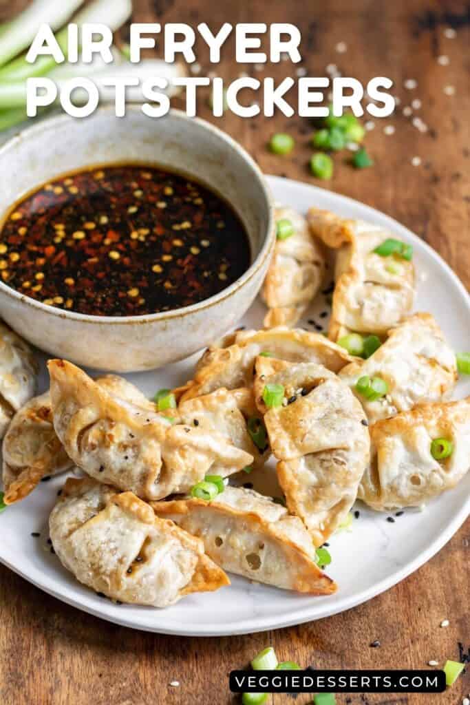 Plate of air fried frozen potstickers with a bowl of dipping sauce.