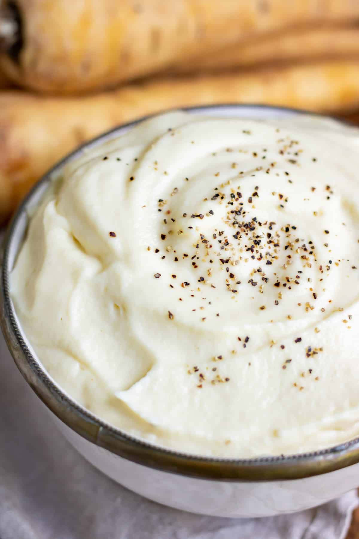 Close up of a dish of parsnip puree.