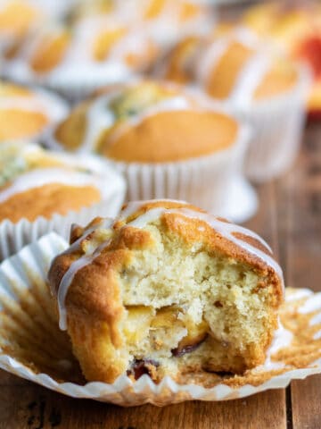 Bite out of a peach muffin.