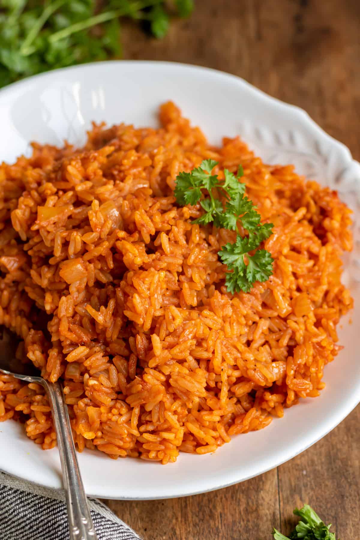 Close up of a spoon in a serving dish or seasoned rice.