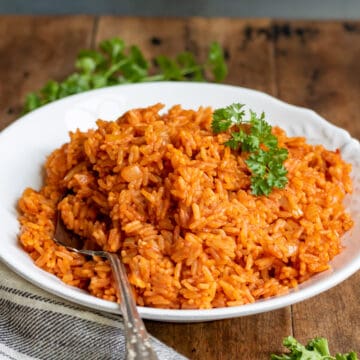 Dish of seasoned rice with a serving spoon in it.