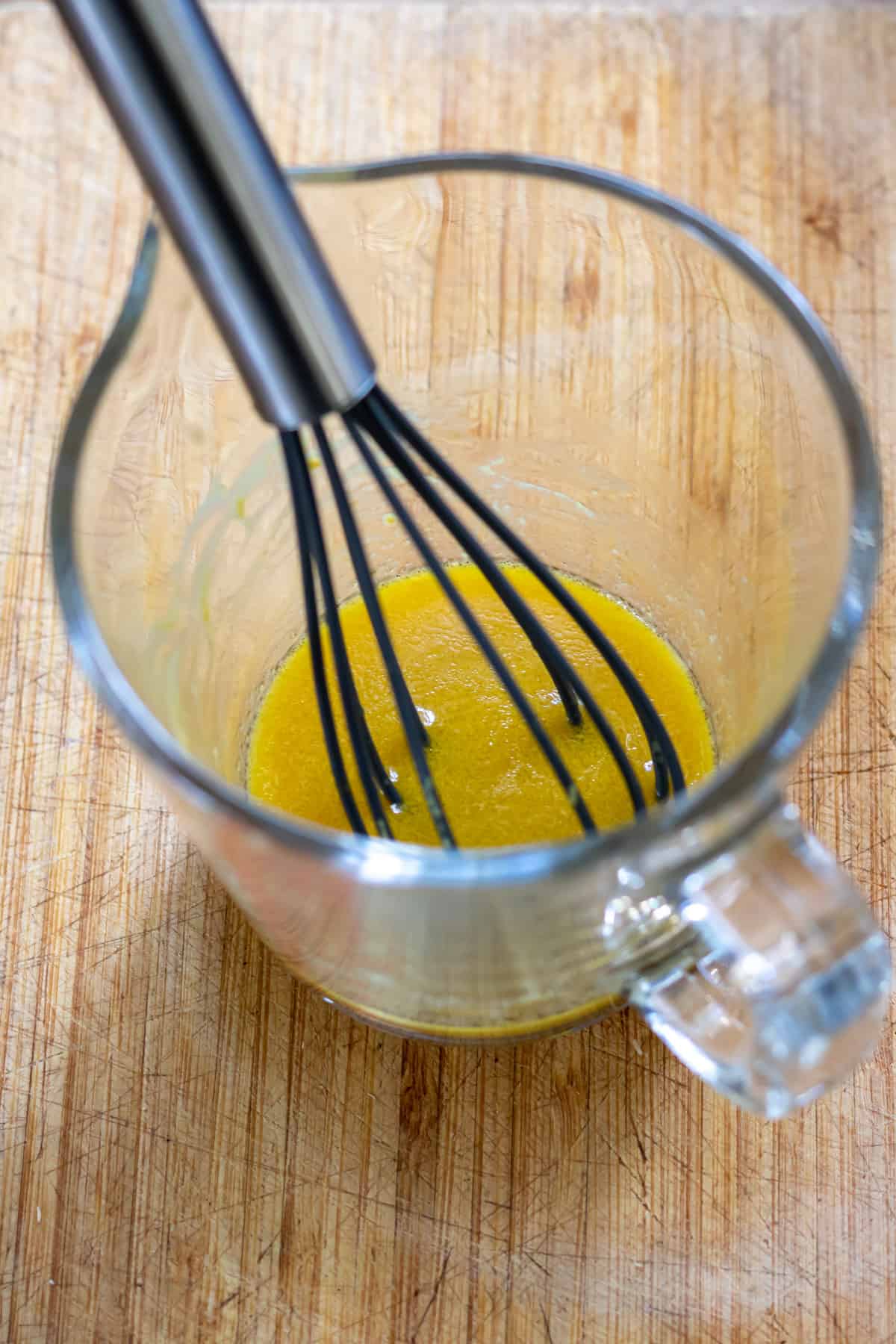 Whisking dressing in a jug.