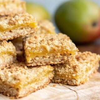 Pile of mango bars on a wooden board.