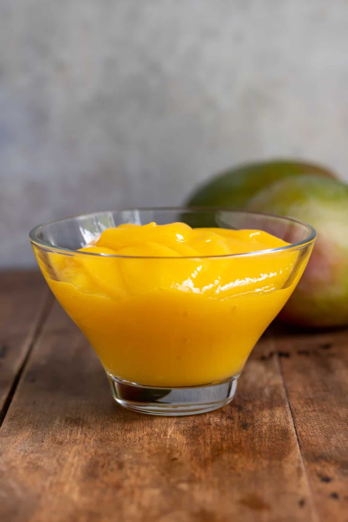Glass bowl of mango puree.