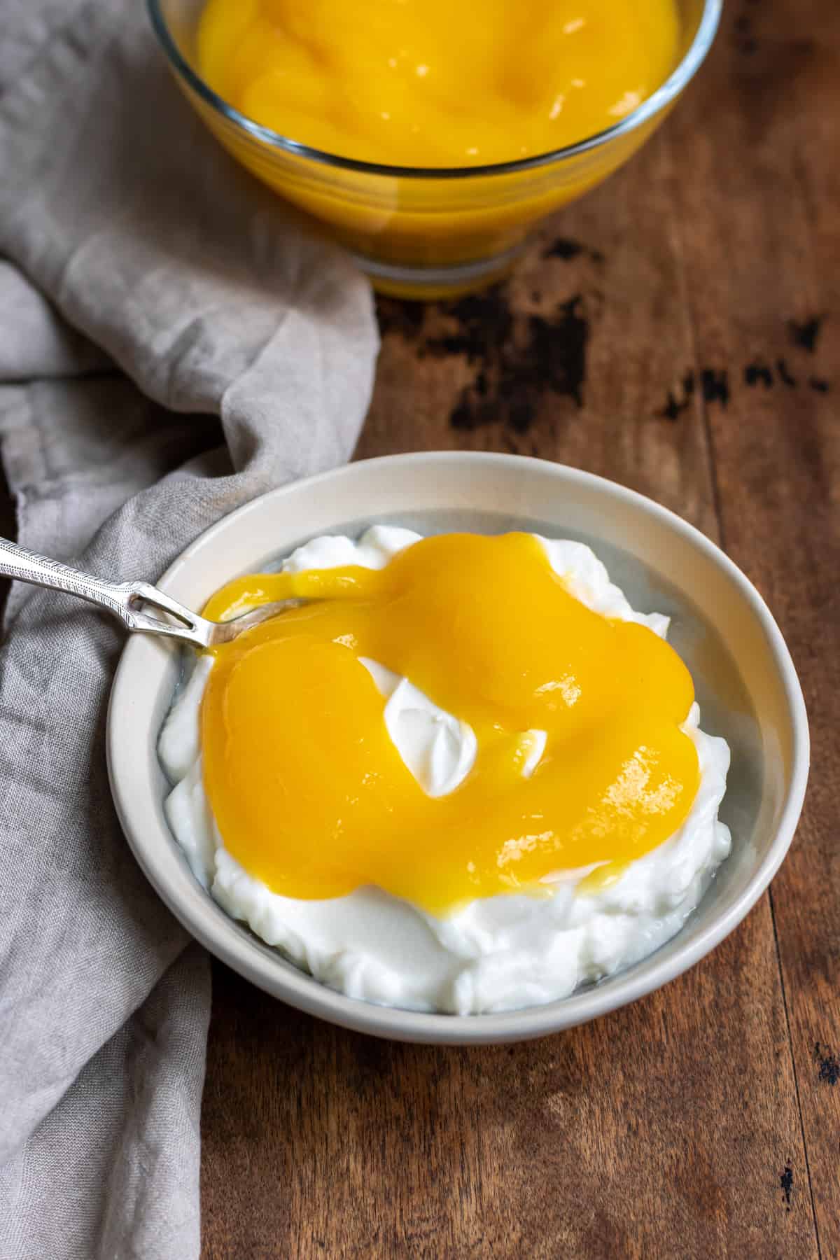 Dish of yogurt topped with mango pulp.