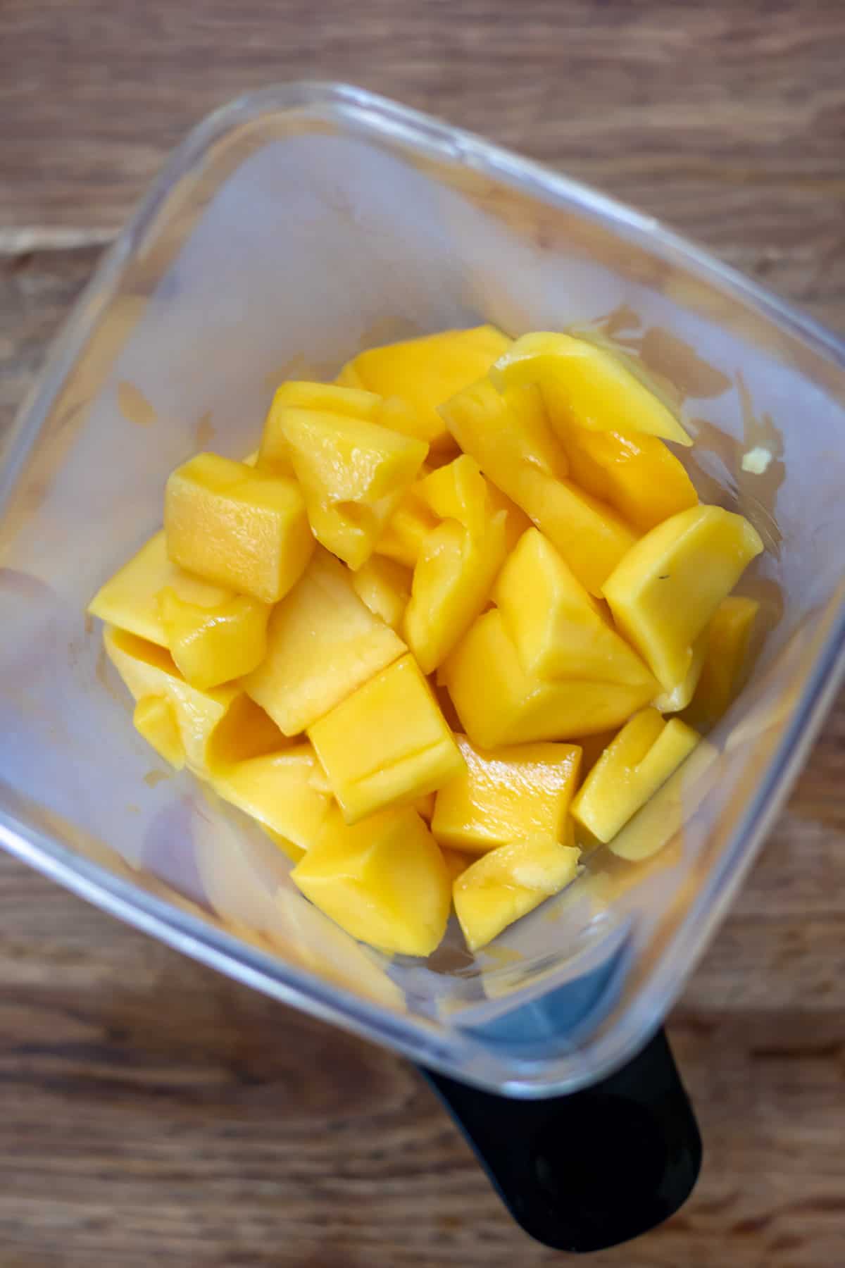 Cubes of mango in a blender.