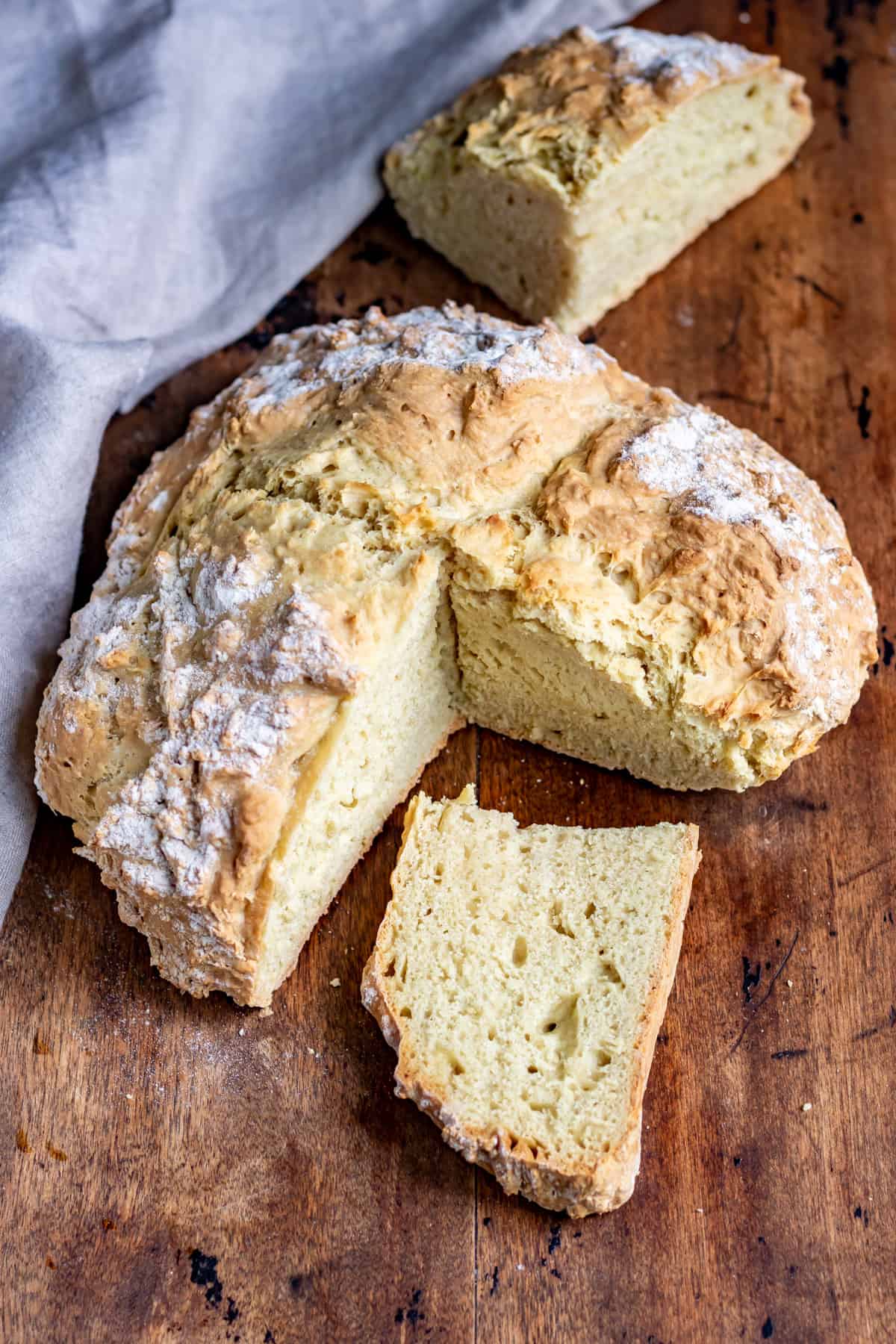 Loaf of soda bread with a piece cut out.