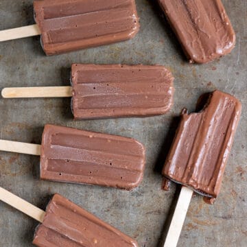 Rows of fudgesicles on a metal board.