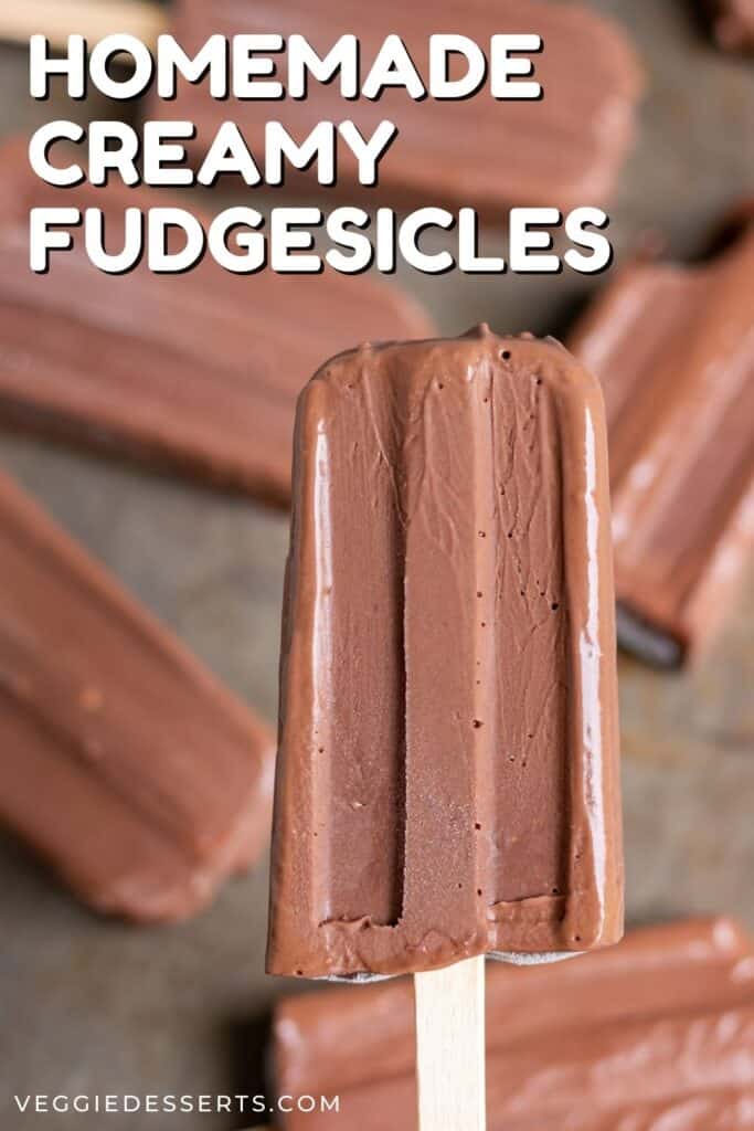 Holding a popsicle, with text: Homemade Creamy Fudgsicles.