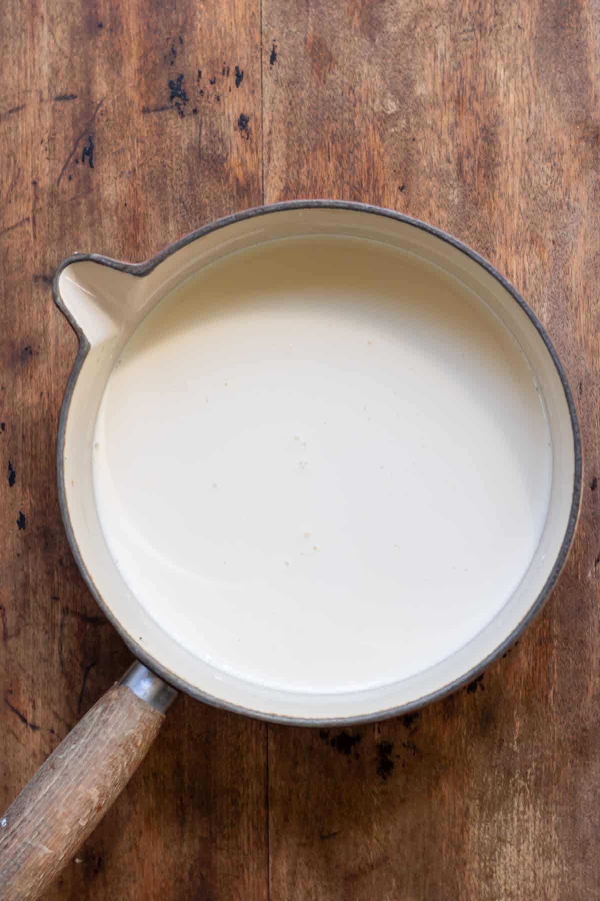 Heating cream and milk in a pot.