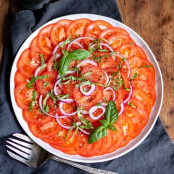 Tomato onion salad on a plate.