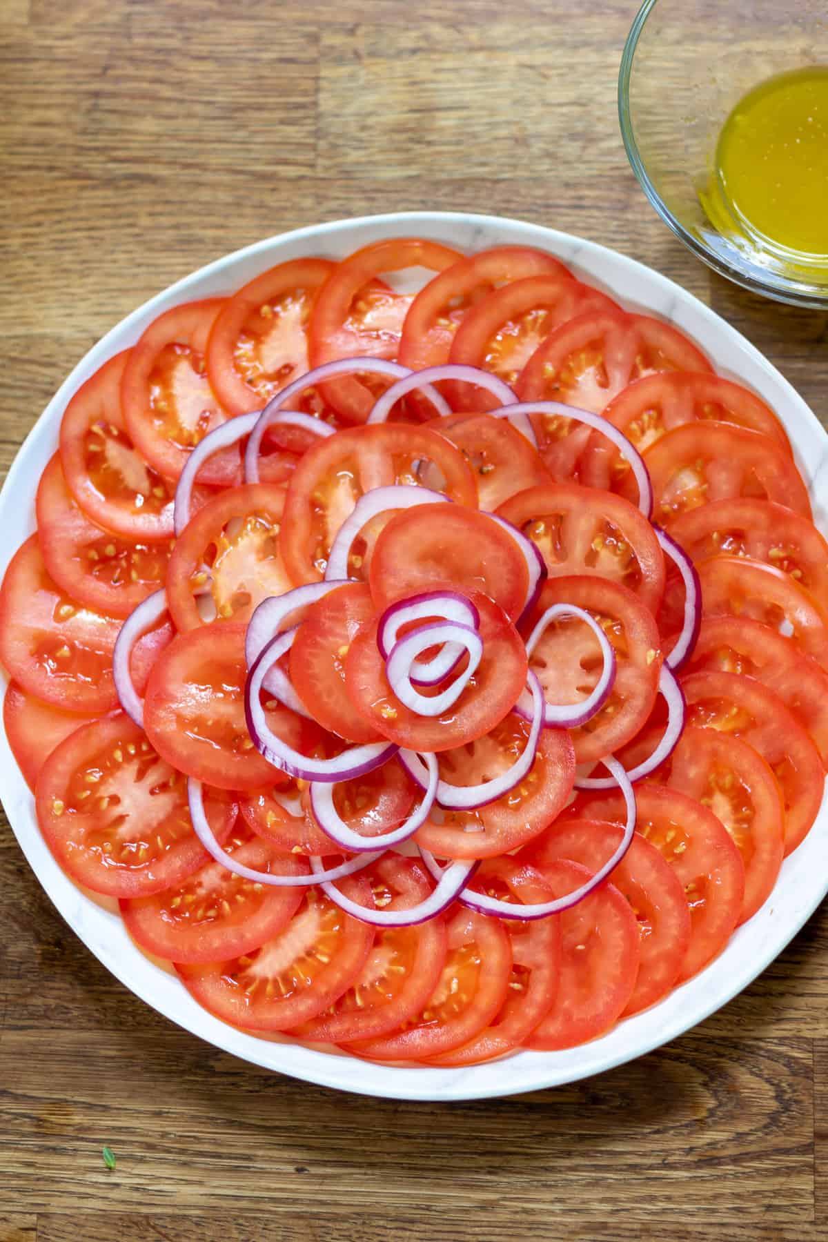 Layering the sliced onion and tomatoes.