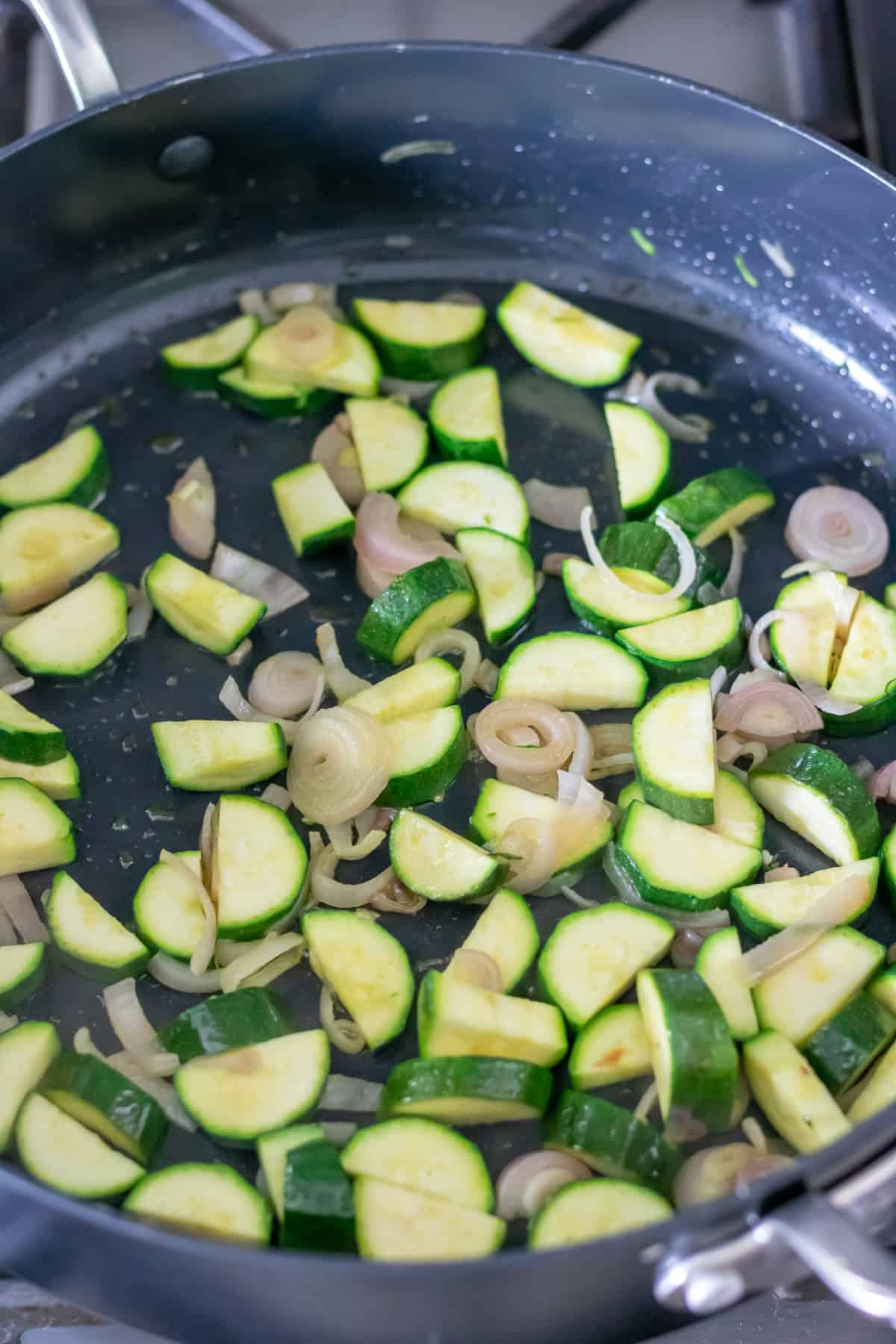 Cooking zucchini and shallots.
