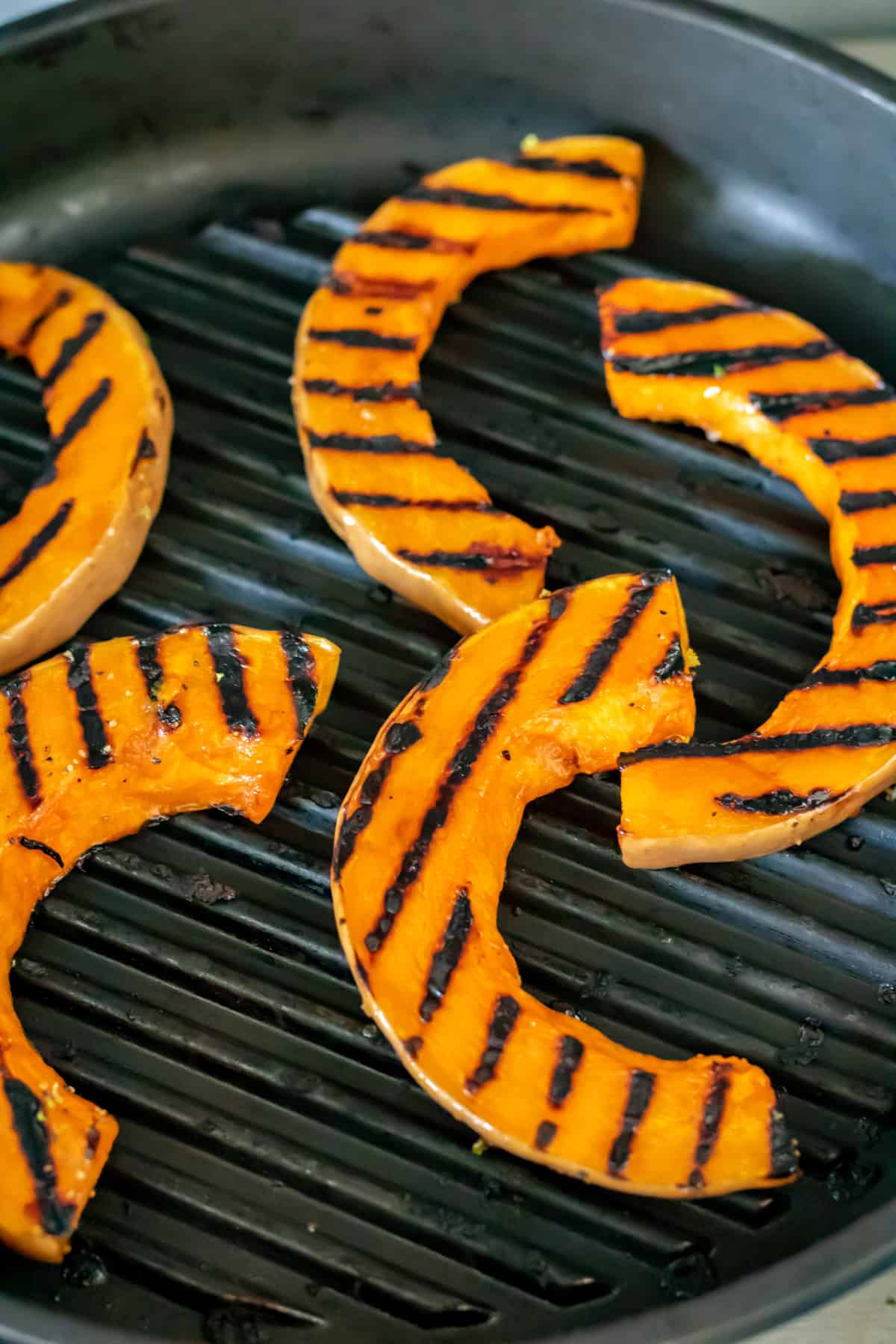Slices of squash being grilled.