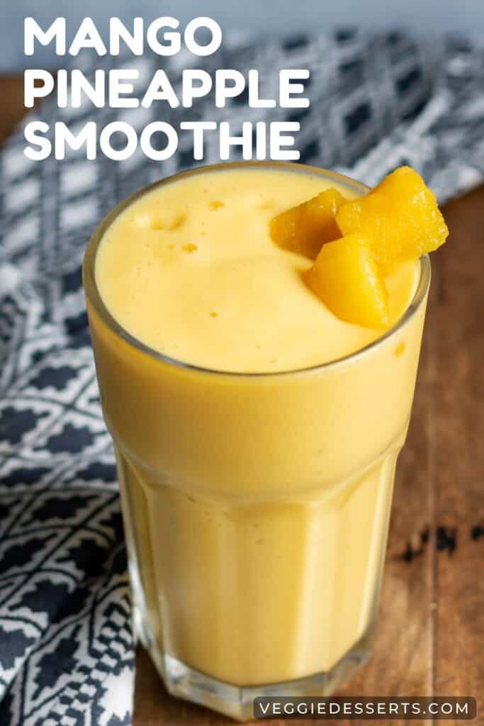Smoothie on a table, with text: mango pineapple smoothie.