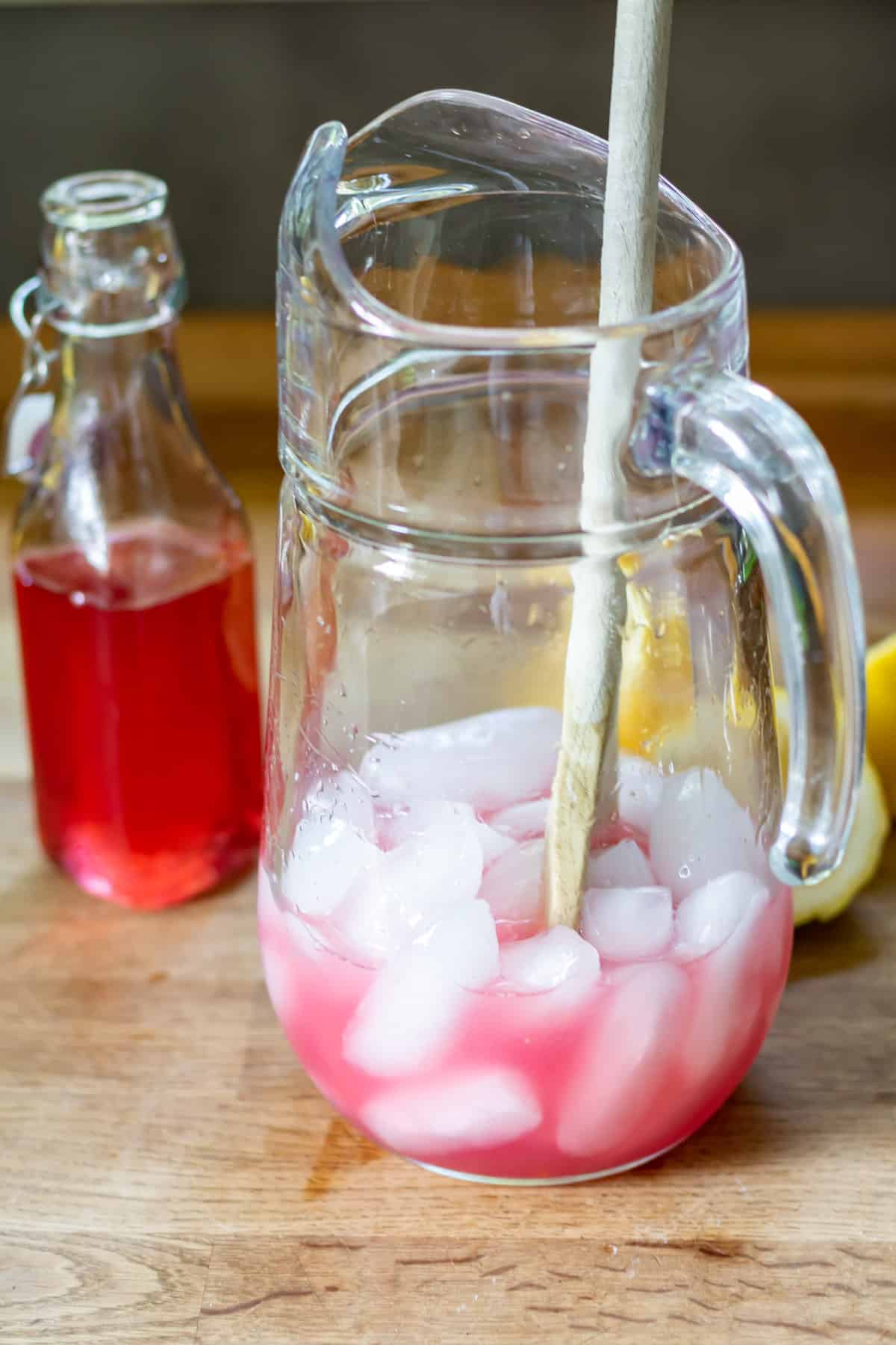 Rose syrup in a pitcher with ice.