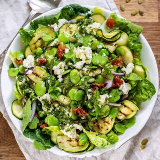 Bowl of broad bean salad on a table.