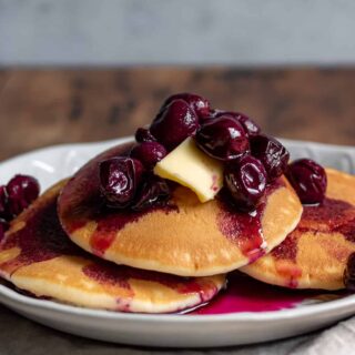 Plate of pancakes topped with Grape Compote.