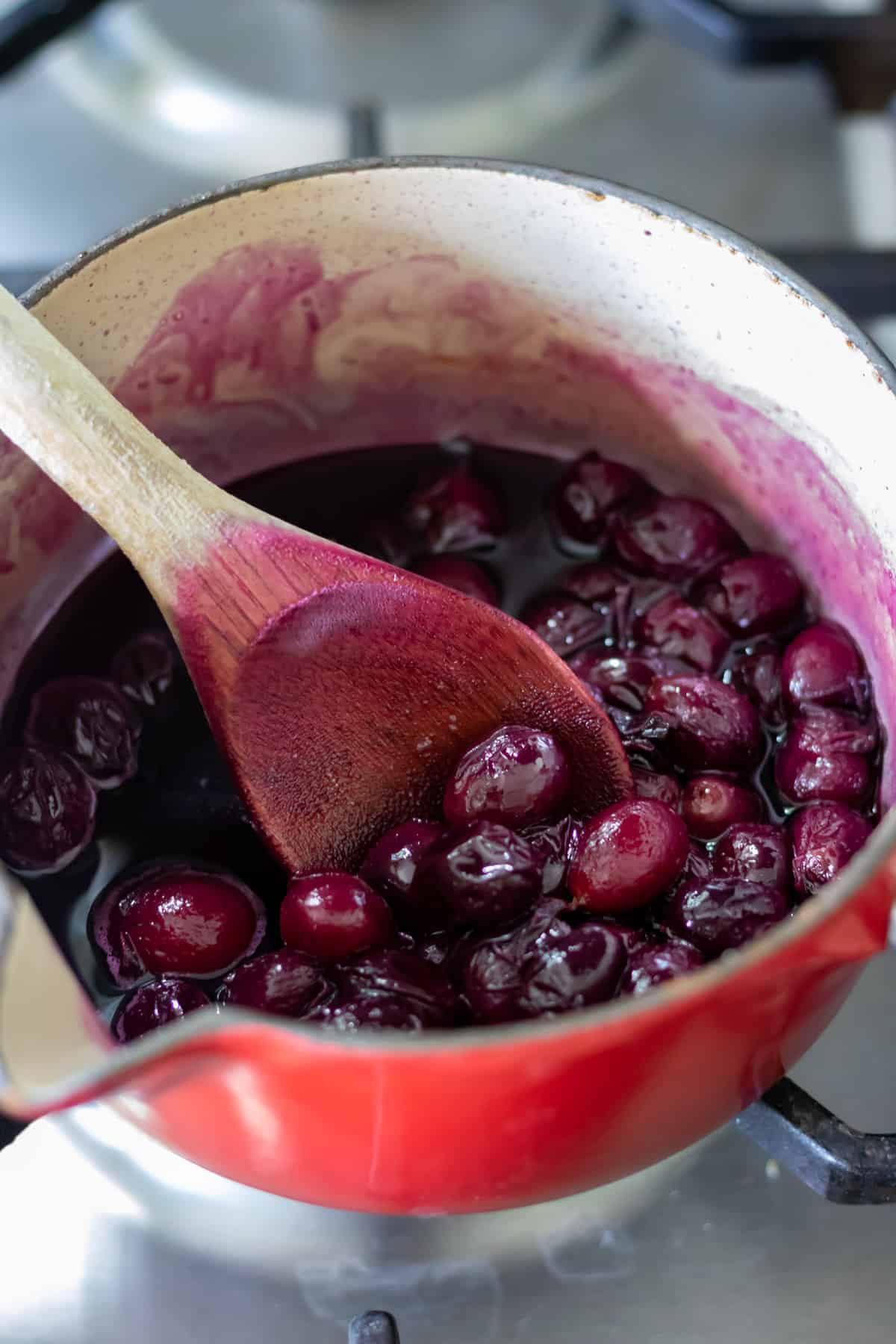 Simmering grapes in a pot.