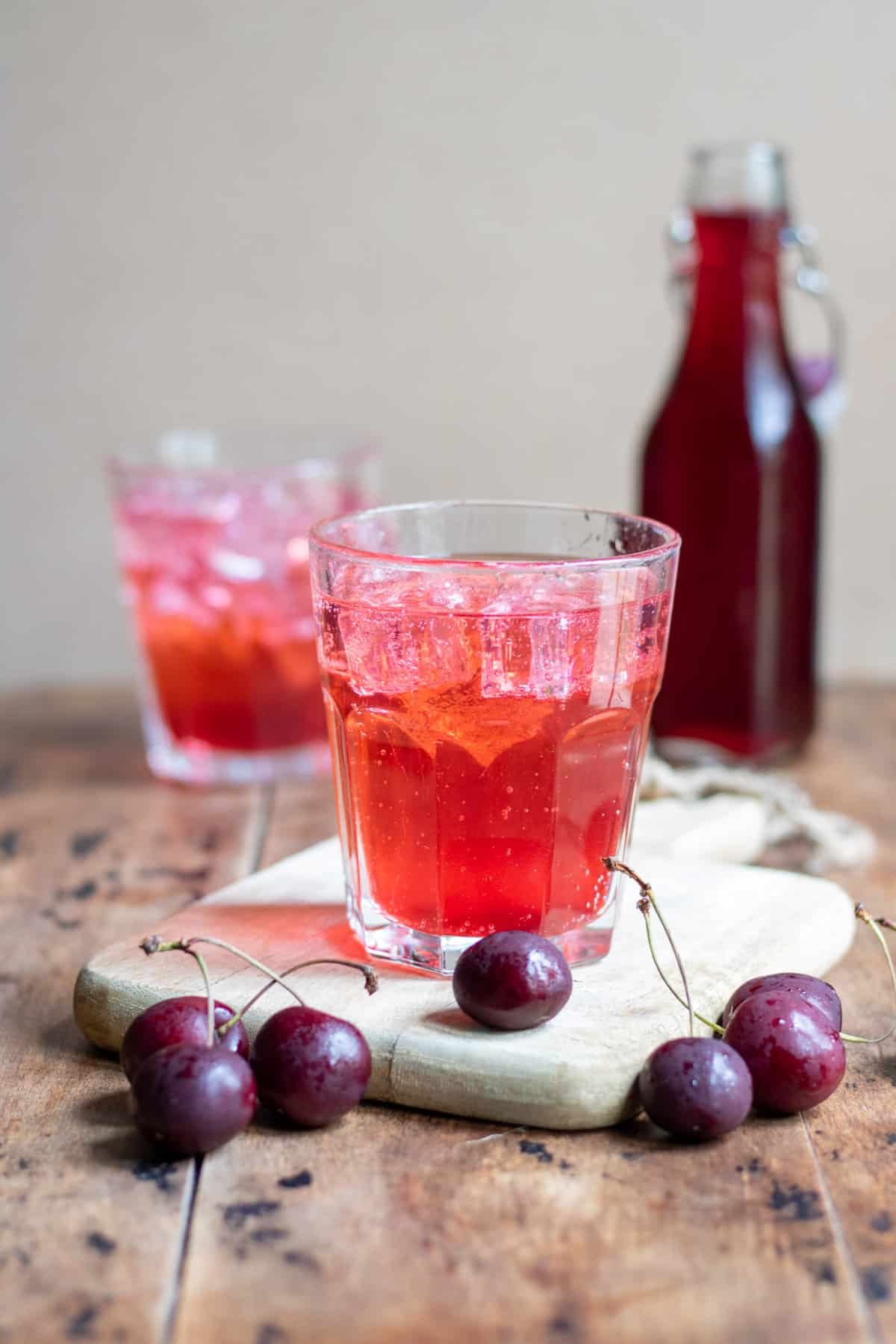 Glasses of soda water with cherry syrup.