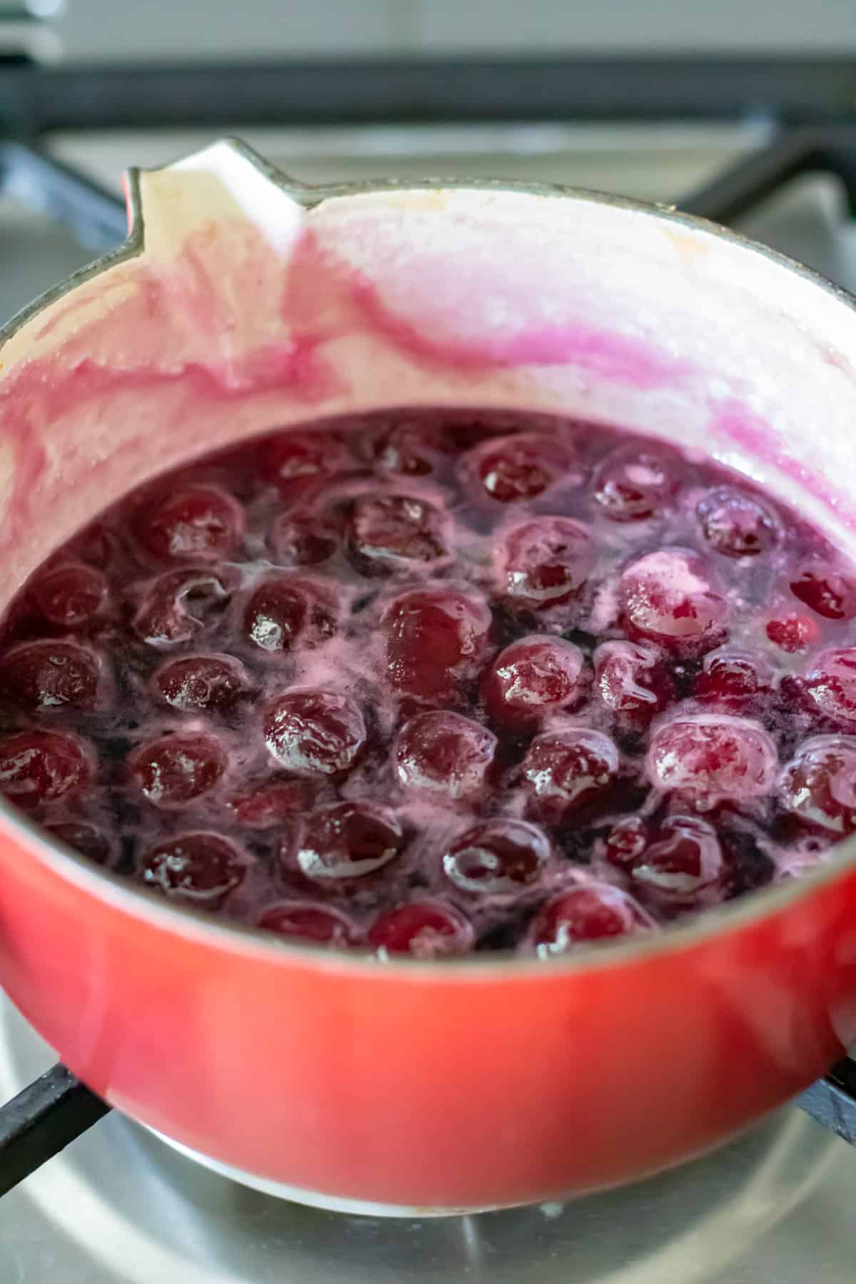 Cooking cherry syrup.