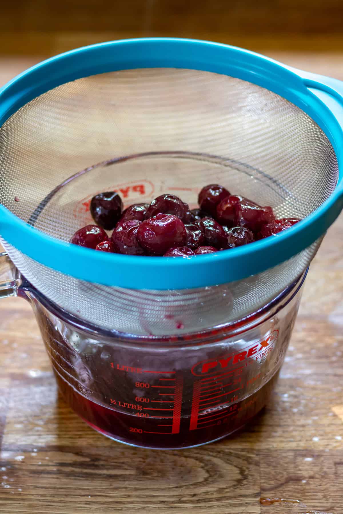 Straining the cherry syrup.
