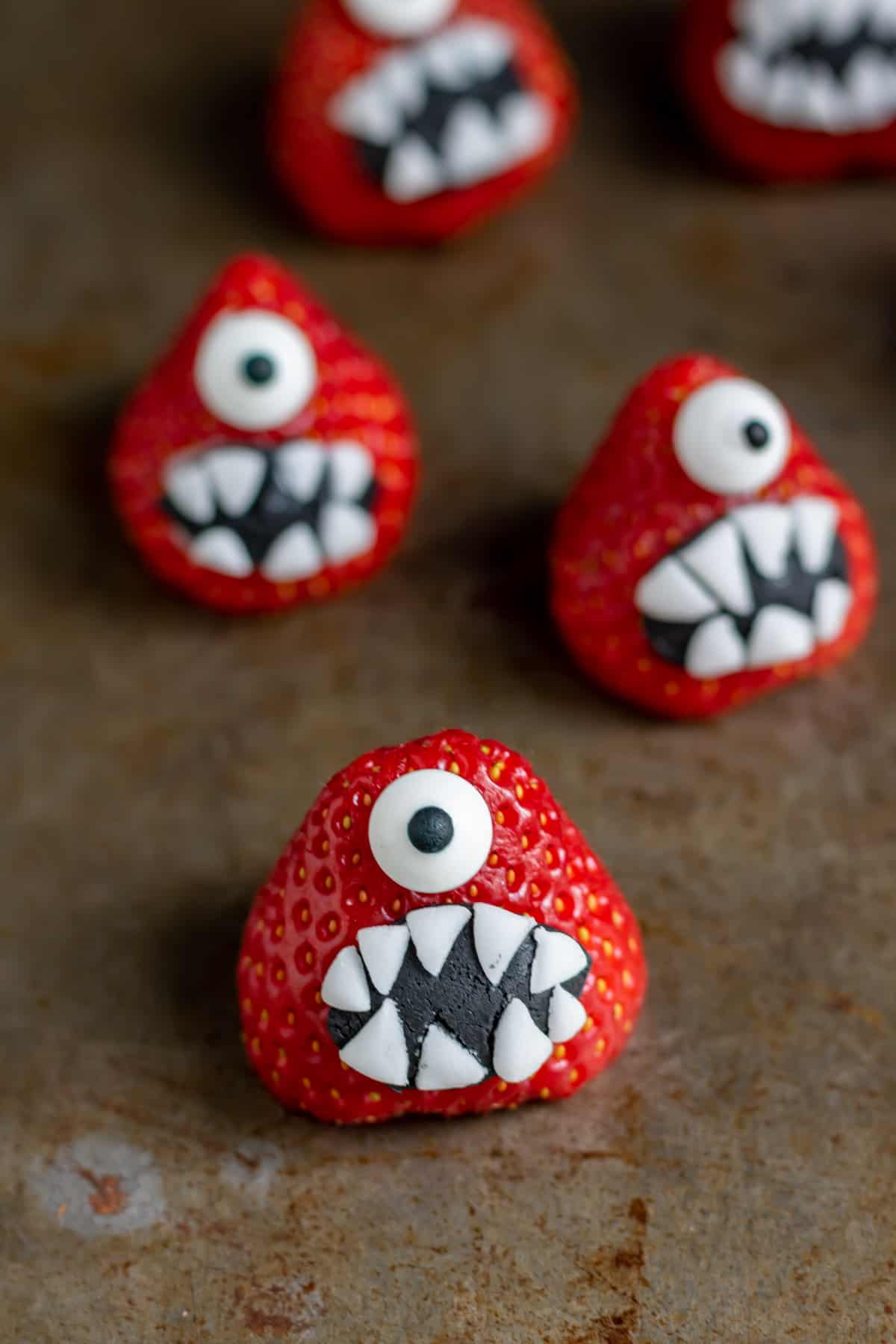Close up of strawberries decorated to look like monsters.