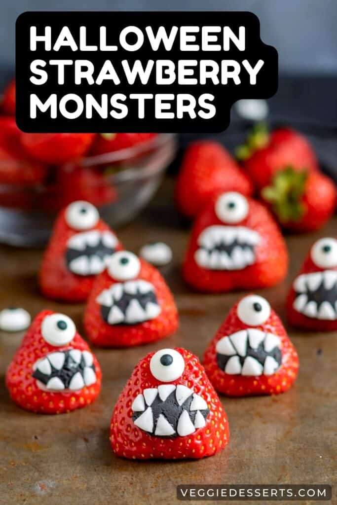 Strawberries decorated to look like monsters, with text: Halloween Strawberry Monsters.
