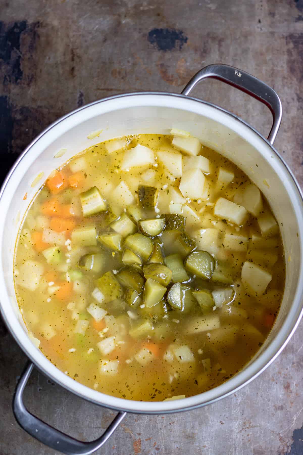 Stock, pickles and potatoes added to the pot.